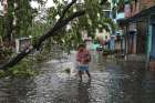 A man crosses a flooded street in Kolkata, India, May 21, 2020, after Cyclone Amphan made its landfall. Following the cyclone, incessant rain and floods have forced hundreds of thousands of people to move to safer places in eastern India&#039;s Assam state.