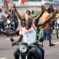 A crowd of supporters parades ahead of opposition leader Etienne Tshisekedi&#039;s convoy as he drives to a polling station in Kinshasa, Congo, Nov. 28. Catholic officials called for calm Nov. 29, a day after violent incidents were reported during Congo&#039;s presidential and legislative elections.