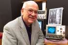 Deacon Pete Schumacher with a VP-8 image analyzing machine at his Shroud of Turin museum. 