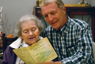 Michael McGouran looks at his Grade 3 report card from St. Monica Catholic School with his 92-year-old mother. 