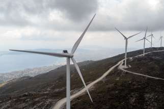 Wind turbines are seen on a mountain near the town of Karystos, on the island of Evia, Greece, April 16, 2021.