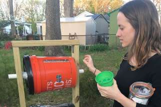 Jane Crosby stands April 17 next to a composting apparatus that she made with her brother outside her home in Springfield, Va. All her food scraps are composted so they can be used later as fertilizer, instead of decomposing and emitting methane gas in a landfill.