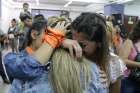 Activists in Mendoza, Argentina, embrace in a courthouse Nov. 25, 2019, after two priests were sentenced to more than 40 years in prison for abusing children at a school for the deaf.