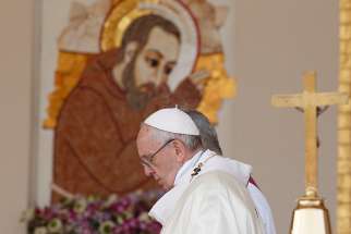 Pope Francis passes an image of St. Pio as he celebrates Mass at the Shrine of St. Pio of Pietrelcina in San Giovanni Rotondo, Italy, March 17.