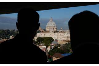 Clergy look out on St. Peter&#039;s Basilica from an upper level of a new building. The Italian government is on &quot;high alert&quot; after a video threat made from the Islamic State group mentioned the country.