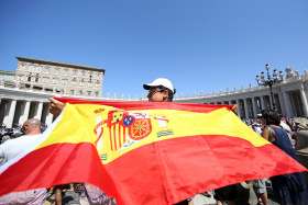 A man holds a Spanish flag as Pope Francis leads the Angelus Aug. 27 in St. Peter&#039;s Square at the Vatican.