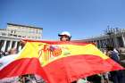 A man holds a Spanish flag as Pope Francis leads the Angelus Aug. 27 in St. Peter&#039;s Square at the Vatican.