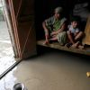 Residents sit inside their flooded house in the Indian state of Assam. Incessant heavy rains in northeast India have caused massive flooding and landslides, leaving at least 126 people dead and affecting 3 million others.