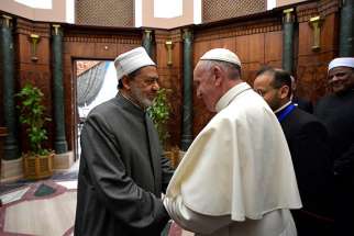 Sheik Ahmad el-Tayeb, grand imam of al-Azhar University, greets Pope Francis at a conference on international peace in Cairo April 28.