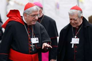 Cardinals Thomas Collins of Toronto and Jorge Urosa Savino of Caracas, Venezuela, talk as they arrive for a session of the Synod of Bishops on the family at the Vatican Oct. 14. 