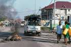 Peacekeepers drive past burning tires as they patrol protests against President Joseph Kabila in Kinshasa, Congo, April 10.