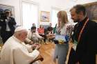 A young woman and a priest from Ukraine give Pope Francis shards from their war-torn country during a private meeting Aug. 3, 2023, at the Vatican nunciature in Lisbon, Portugal. The Vatican said the pope spent half an hour with a group of Ukrainian pilgrims attending World Youth Day, listening to their stories and praying for peace.