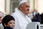 Pope Francis and a child smile from the popemobile as they ride around St. Peter&#039;s Square at the Vatican before his weekly general audience Oct. 18, 2023.