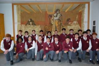 Brotherhood Leadership students from Neil McNeil High School pose in front of the mural in the newly opened chapel.