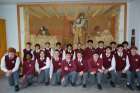 Brotherhood Leadership students from Neil McNeil High School pose in front of the mural in the newly opened chapel.