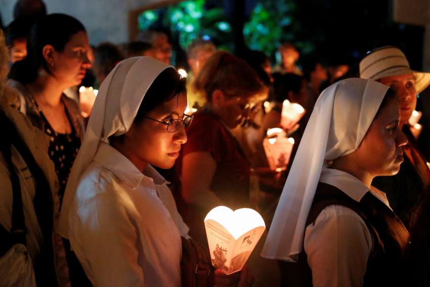 Salvadorans participate in the traditional procession of lights Nov. 16, 2024, at the Central American University in San Salvador, during the commemoration of the 35th anniversary of the Jesuit martyrs. In 1989, six Jesuits, their housekeeper and her daughter were murdered on the Central American University campus.