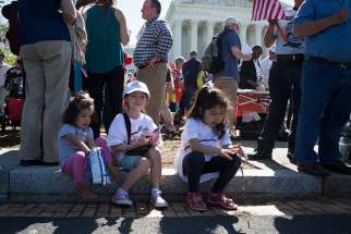 An immigration rally takes place April 18 outside the U.S. Supreme Court in Washington. The U.S. bishops&#039; migration committee chair in a July 18 statement urged President Donald Trump to &quot;ensure permanent protection&quot; for youth under the Deferred Action for Childhood Arrivals program, or DACA.