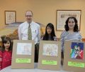 From left, Anna Kubovych, 6, Jade Cruz, 11, and Allegra Fiorino, 13, received a $100 gift certificate from Broughton Church Supplies. With the girls is Steve Atkinson, floor manager at Broughton’s.