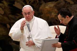 Pope Francis delivers his blessing during his general audience in Paul VI hall at the Vatican Jan. 18.