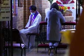  Father Jiha Lim listens to a penitent’s confession March 7, 2021, at St. Aloysius Church in Great Neck, N.Y., during the COVID-19 pandemic. The Vatican says general absolution still is permissible where infections continue to rise.