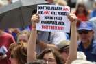 A woman holds a sign during a rally against physician-assisted suicide on Parliament Hill in Ottawa in this file photo.