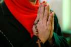 A woman prays at the Holy Family Church in Srinagar, India, Dec. 25, 2017.