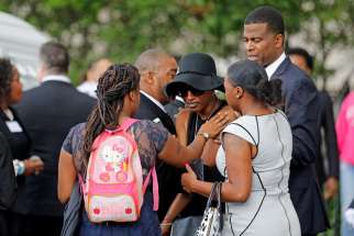 Family members comfort Diamond Reynolds, the girlfriend of Philando Castile, as his casket arrives July 14 for a funeral service at the Cathedral of St. Paul in St. Paul, Minn. Church officials said the mother of 32-year-old man, who was not Catholic, requested the cathedral hold an ecumenical service for her son. Castile was shot and killed by a police officer July 6.