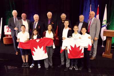 Team Canada members from the 1972 Summit Series (back row) pose with select students from the Niagara Catholic school board. The board struck a curriculum development partnership with the team.