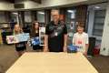 St. John XXIII teacher Manfred von Vulte with students (from left) Jamilee Lynch, Kennedy Smith and Joseph Chiodo with some of the art they have sold for charity.