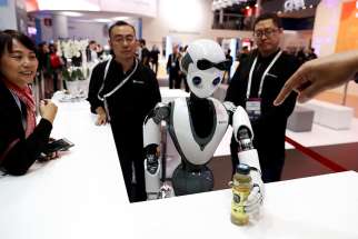 The CloudMinds XR-1 robot performs for visitors at the Mobile World Congress in Barcelona, Spain Feb. 25, 2019. Technology holds the potential to benefit all of humankind, but it also poses risky and unforeseen results, Pope Francis said. 