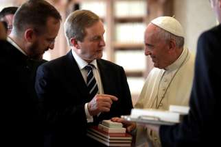Pope Francis exchanges gifts with Irish Prime Minister Enda Kenny during a private audience at the Vatican Nov. 28.