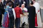 Pope Francis receives a bouquet of flowers from a group of children as he arrives Sept. 11, 2024, in Singapore, the last stop on his four-nation visit to Asia and the Pacific.