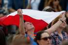 A woman waves Poland&#039;s flag as Pope Francis leads the &quot;Regina Coeli&quot; from the window of his studio overlooking St. Peter&#039;s Square at the Vatican April 26.