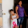 Veronica Castro stands with daughter Jennifer Berrelleza Castro at the front entrance of their home in Phoenix May 9. Castro, who has been living illegally in the United States for several years, said that because her husband was deported she planned to return to Sinaloa, Mexico, with her four children, who are legal citizens.