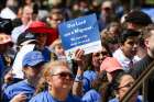 A woman holds up a sign supporting the needs of migrants during Texas Advocacy Day at the Texas Capitol in Austin April 4.