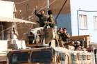 Members of Syrian National Army, known as the Free Syrian Army, react as they drive on top of an armored vehicle Oct. 11, 2019, in the Turkish border town of Ceylanpinar. Dozens of advocacy organizations participating in the International Religious Freedom Roundtable called on U.S. President Donald Trump &quot;not to abandon Christians, Yazidis and Kurds&quot; in the Syrian border region that Turkey is bombing.