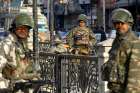 Indian paramilitary soldiers stand guard Jan. 22 in Srinagar, near the India-Pakistan border. More than 40,000 villagers have fled their homes since Indian and Pakistani soldiers began exchanging fire across their borders. 