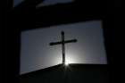 A cross atop a Catholic church is silhouetted in Tianjin, China.