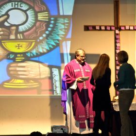 Jesuit Father Len Altilia with students at Marshall McLuhan&#039;s Ash Wednesday school Mass. Behind them is the &quot;Witness to Faith Cross.&quot; The cross was built by Neil McNeil High School students to tour Toronto Catholic schools during the school board&#039;s &quot;Year of Witness.&quot;