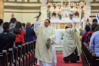 Father Todd Carpenter and Deacon Angel Rivera bless the congregation with holy water during the Easter Vigil in 2016 at St. Paul Church in Wilmington, Del. The Roman Missal, which spells out specifics of how the vigil is to be celebrated, describes it as the &quot;mother of all vigils.&quot;