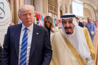 U.S. President Donald Trump walks with Saudi King Salman during the opening session of the Gulf Cooperation Council summit May 21 in Riyadh, Saudi Arabia.