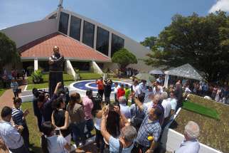Well-wishers gather July 9 at the dedication of a statue honoring Franciscan Father Flavian Mucci in Sonsonate, El Salvador. The statue marks the arrival of Father Mucci to El Salvador, where the founder of the Agape Association of El Salvador has served the poor for 50 years.