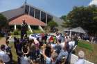 Well-wishers gather July 9 at the dedication of a statue honoring Franciscan Father Flavian Mucci in Sonsonate, El Salvador. The statue marks the arrival of Father Mucci to El Salvador, where the founder of the Agape Association of El Salvador has served the poor for 50 years.