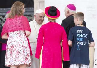 Pope Francis greets a prelate and young people during a special audience with altar servers July 31 in St. Peter&#039;s Square at the Vatican.