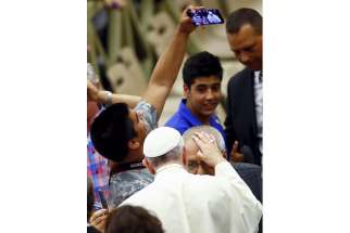 Archbishop Bernardito Auza said everyone wants to see the Pope because of the interest in the Laudato Si’ encyclical. In this photo, a man makes a selfie as Pope Francis blesses a pilgrim during the pontiffs weekly audience in Paul VI hall at the Vatican Aug. 12.