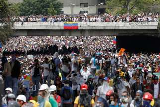 Demonstrators rally against Venezuelan President Nicolas Maduro in Caracas, Venezuela, May 3. Two days later, Pope Francis urged the country&#039;s bishops to remain close to the poor and needy.