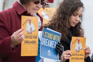 At right, Maria Jose, a recipient of the Deferred Action for Childhood Arrivals program, joins participants at a Feb. 6 prayer service outside the U.S. Capitol to pray for Dreamers and for legislators who are working to pass immigration legislation. 