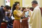 A priest distributes communion at the Cathedral-Basilica of Notre-Dame of Quebec in Quebec City. Masses in the province are being cancelled because of the COVID-19 virus. 