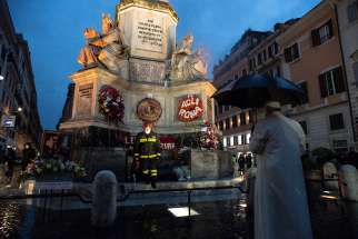 Pope Francis prays at the base of a tall Marian statue overlooking the Spanish Steps in Rome Dec. 8, 2002, the feast of the Immaculate Conception. The pope prayed at the statue shortly before the Rome firefighters&#039; traditional early morning event in honor of the Immaculate Conception. 
