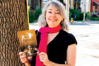Mary Marrocco poses with her book, &#039;On Becoming Bread.&#039;